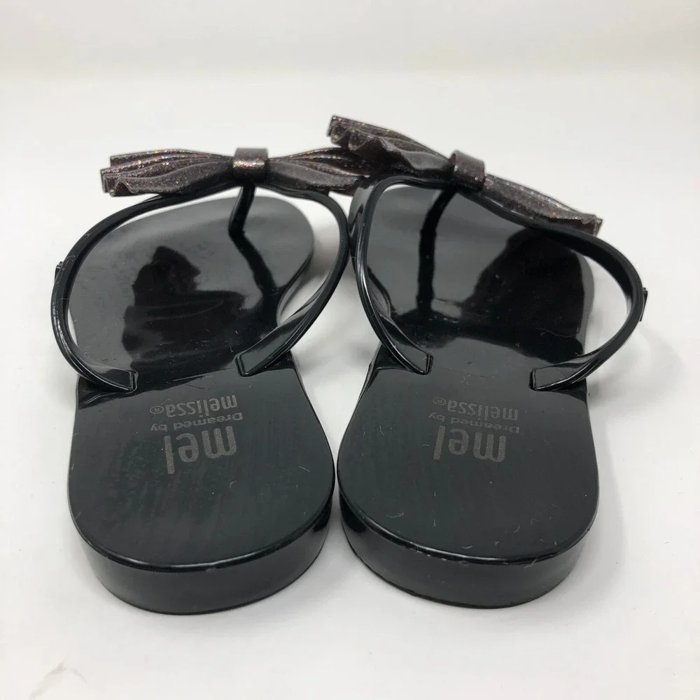 Melissa Mel Harmonic Bow Vi INF Flip Flops Girls 1 Black Glitter Scented